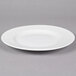 A white Reserve by Libbey wide rim porcelain plate on a white background.
