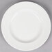 A white Reserve by Libbey porcelain plate with a wide rim on a gray surface.