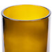 An Arcoroc amber wine tumbler with a yellow rim.