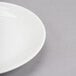 A close up of a white Reserve by Libbey Royal Rideau coupe plate with a white rim.