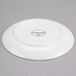 A white Reserve by Libbey Royal Rideau porcelain coupe plate with a small black logo.