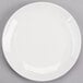 A white Reserve by Libbey Royal Rideau coupe plate on a gray surface.