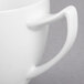 A close-up of a white Royal Rideau porcelain cup with a handle.
