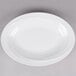 A white Reserve by Libbey narrow rim porcelain platter with a curved edge.