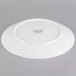 A white Reserve by Libbey porcelain coupe plate with a circular design on it.