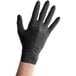 A hand wearing a Lavex black nitrile glove.
