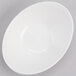 A close up of a white oval bowl with a white rim.