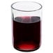 A clear Arcoroc wine tumbler filled with red liquid.