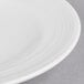 A close-up of a Reserve by Libbey white porcelain saucer with a thin rim.