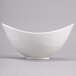 A close-up of a white Reserve by Libbey Royal Rideau bowl with a curved edge.
