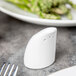A white Royal Rideau porcelain salt shaker on a table.