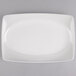 A white rectangular porcelain platter with a thin curved edge.