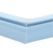 A close up of a blue plastic corner with a white background.