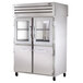 A large stainless steel True pass-through refrigerator with glass and solid half doors.