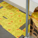Yellow Spilfyter absorbent pads on the floor with yellow warning signs.