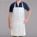 A man wearing a Chicopee white disposable food service apron.