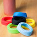 Tablecraft silicone squeeze bottle bands in a variety of colors on a table.