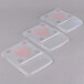 Three clear plastic Edlund ClearShield scale covers with red writing.