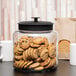 An Anchor Hocking Montana jar filled with cookies on a table.