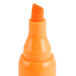 A close-up of a Universal fluorescent orange chisel tip highlighter.