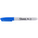 A close up of a Sharpie blue fine point permanent marker with a black cap.