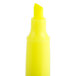 A close-up of a Universal fluorescent yellow chisel tip highlighter pen.