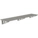 A long stainless steel slotted wall shelf.