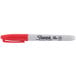 A red Sharpie permanent marker with a white cap.