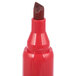 A close-up of a red Universal desk style permanent marker with a brown chisel tip.