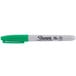 A close up of a green Sharpie permanent marker with a white cap and tip.