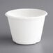 A white EcoChoice bagasse portion cup with a white lid.