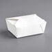 A white Choice folded paper take-out box on a gray surface.