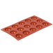A red silicone Matfer Bourgeat mini half sphere mold with 15 compartments.