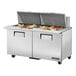 A stainless steel True 2 door refrigerated sandwich prep table on a counter.