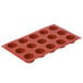 A red silicone round petit fours mold with 15 compartments.