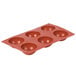 A red silicone Matfer Bourgeat 6 compartment half sphere mold.