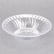 A clear plastic Fineline Flairware bowl with a scalloped edge.