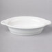 A white oval Fiesta casserole dish on a gray surface.