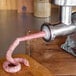 A Weston meat grinder with a sausage being made.
