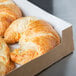A 9" x 9" Kraft bakery box with a window filled with croissants.