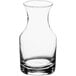 An Acopa clear glass carafe with a curved neck on a white background.