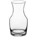 An Acopa clear glass carafe with a white top.