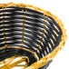 A black and gold Thunder Group rattan cracker basket with a handle.