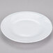 A CAC Roosevelt super white porcelain plate with a wavy design.