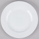 A CAC Roosevelt white porcelain plate on a gray surface.