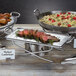 An American Metalcraft hammered stainless steel griddle with meat and rice on it.