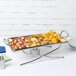 A small rectangular stainless steel griddle stand holding a tray of food.