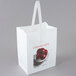 A white bag with a picture of apples on it.