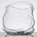 A clear glass vase with a wavy design.