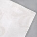 A close up of a white Hoffmaster Linen-Like paper guest towel.